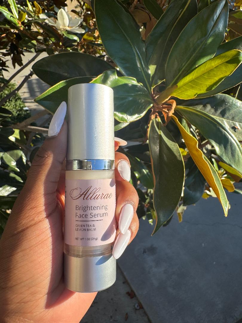 Allurae Brightening Face Serum held against green leaves in sunlight